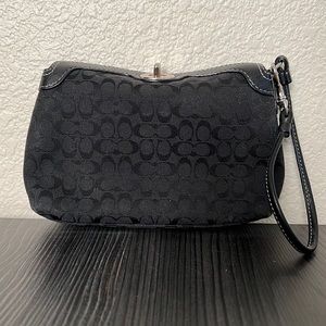 Coach black jacquard wristlet with leather closure and white stitching